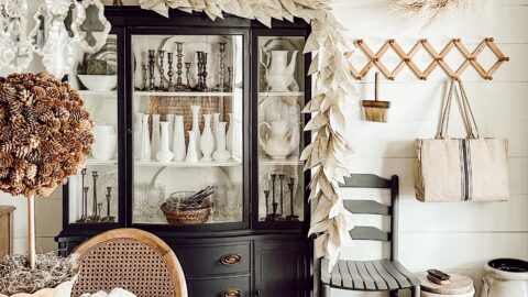 Dining Room Decorating for Fall with Book page leaf garland over a black painted hutch