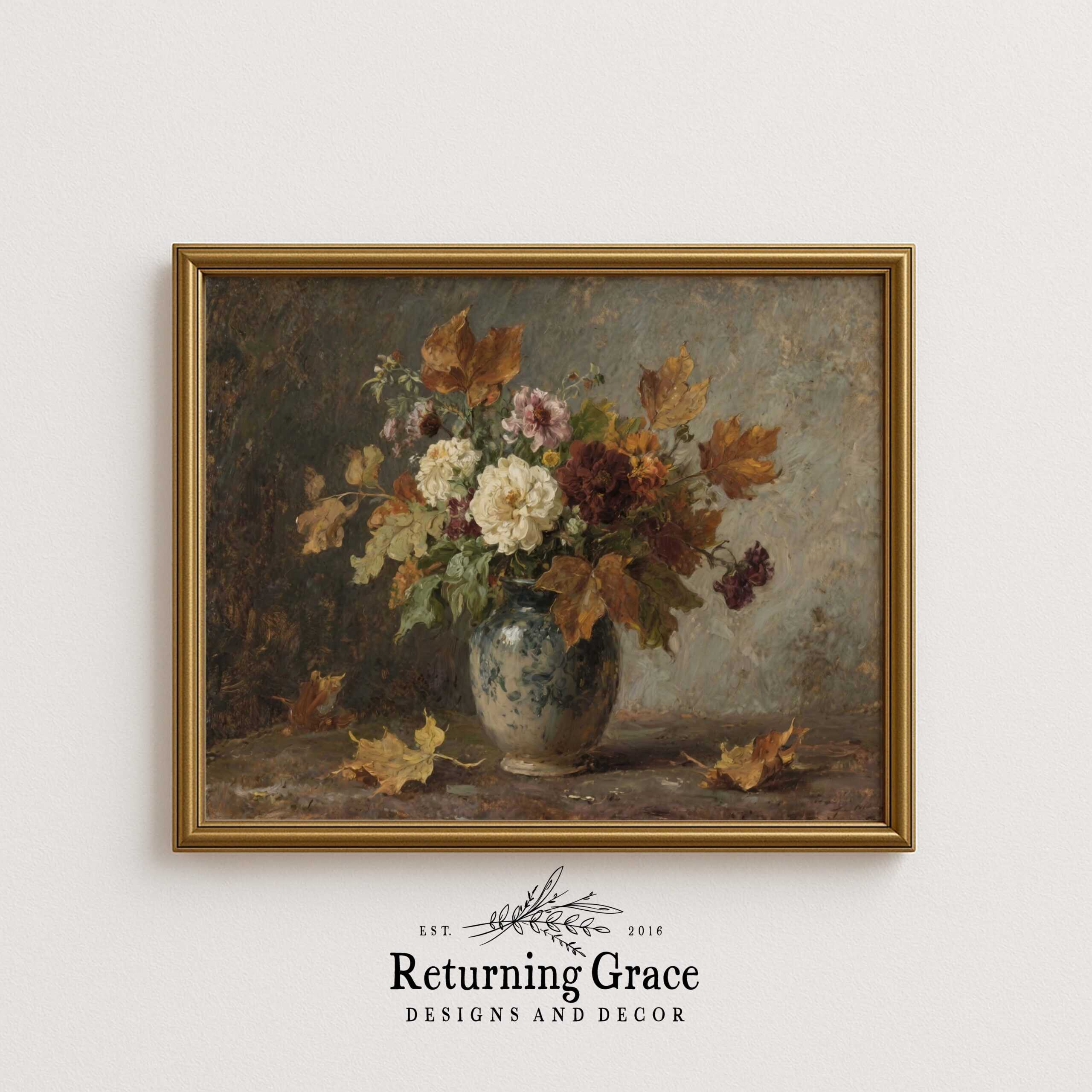 A framed piece of vintage wall art depicting a floral arrangement in a ceramic vase, with colorful flowers and autumn leaves, hangs on a plain white wall above the Returning Grace Designs and Decor logo.