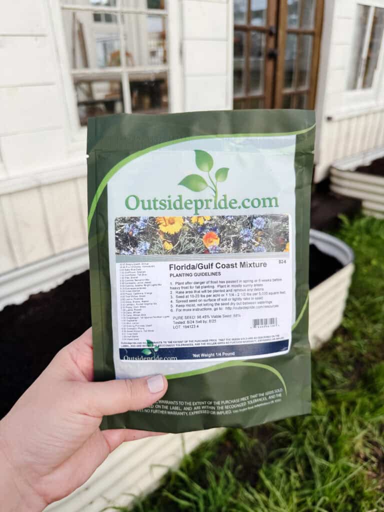 A hand holding a green bag with a label.